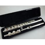 A Yamaha white metal flute, model 211, cased.