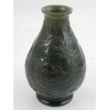 A Chinese spinach green jade vase, decorated with a continous design of Foo dogs. H.