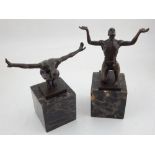 A pair of bonze male figures, each in an athletic pose, raised on a marble base, 19cm,