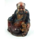 A Chinese soapstone figurine of seated Buddha. H.