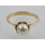 A 9 carat yellow gold and pearl ring. stamped 375 to shank.