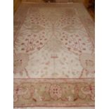 A cream ground Ziegler rug, of foliate design, sage border, fringed, L.380, W.