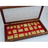 Royal Stamps of the Empire ingots by Danbury Mint, 25 silver gilt stamp replicas with fitted case.