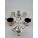 A silver cruet set, London 1954, including a mustard, two twin handle salts and a pepper,