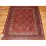 A Turkish Ushak carpet, with a stylized red leaf ground within a broad multi panel border,