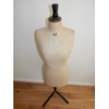 A 20th century tailor's mannequin, the torso upholstered in cream calico, H. 150cm.