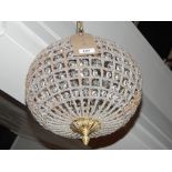 A pair of ball shaped ceiling lights, the metal frame set with crystals,