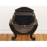 A cast iron fire grate, with bowed front with twin urn finials, on scrolling front feet, H: 62cm, W:
