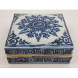 A Chinese blue and white porcelain square box and cover, decorated with scrolling foliate design.