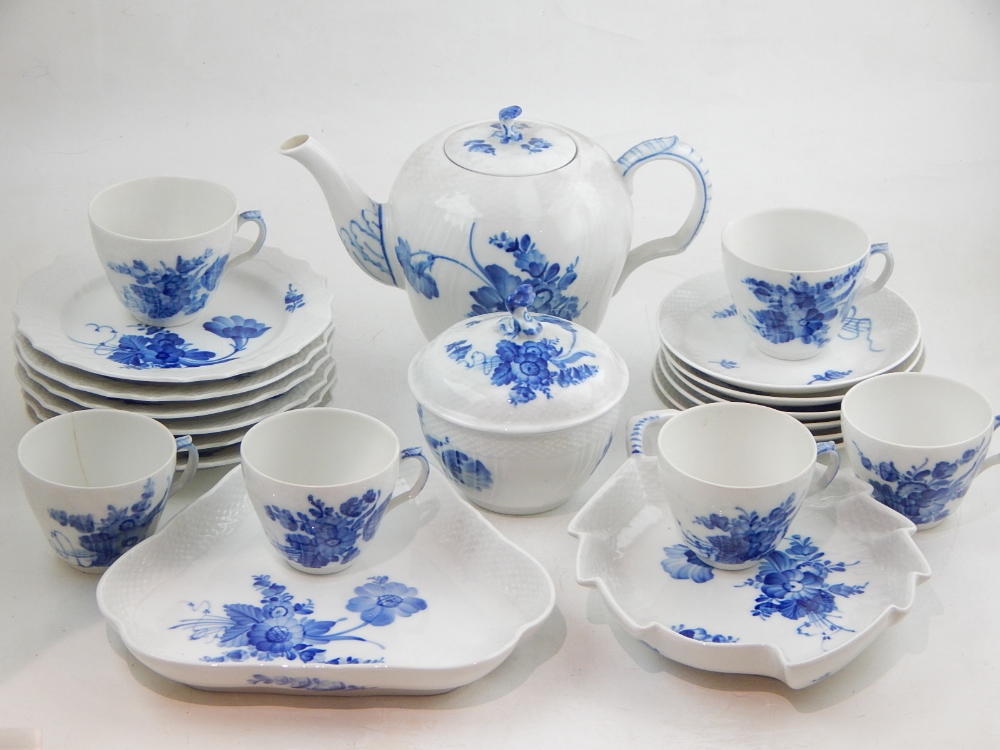 A Royal Copenhagen 'Blå Blomst' tea service to include cups and saucers, tea pot, serving trays, and