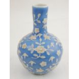 A Chinese light blue glazed baluster vase with elongated neck, relief decorated with flowers and