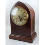 An early 20th century mahogany lancet shaped bracket clock, the enamel dial with Roman numerals