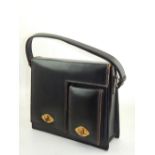 A French vintage black leather handbag, with a cream interior.