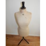 A 20th century tailor's mannequin, the torso upholstered in cream calico. H. 150cm