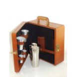 A tan leather travelling cocktail case, the interior fitted with shaker, aluminium beakers, bottle