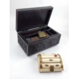 A carved ebonised box, with fitted interior, together with a a bone small jewellery box and small