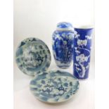 A Kangxi style porcelain vase, decorated with blossoms on a blue ground, together with a pair of