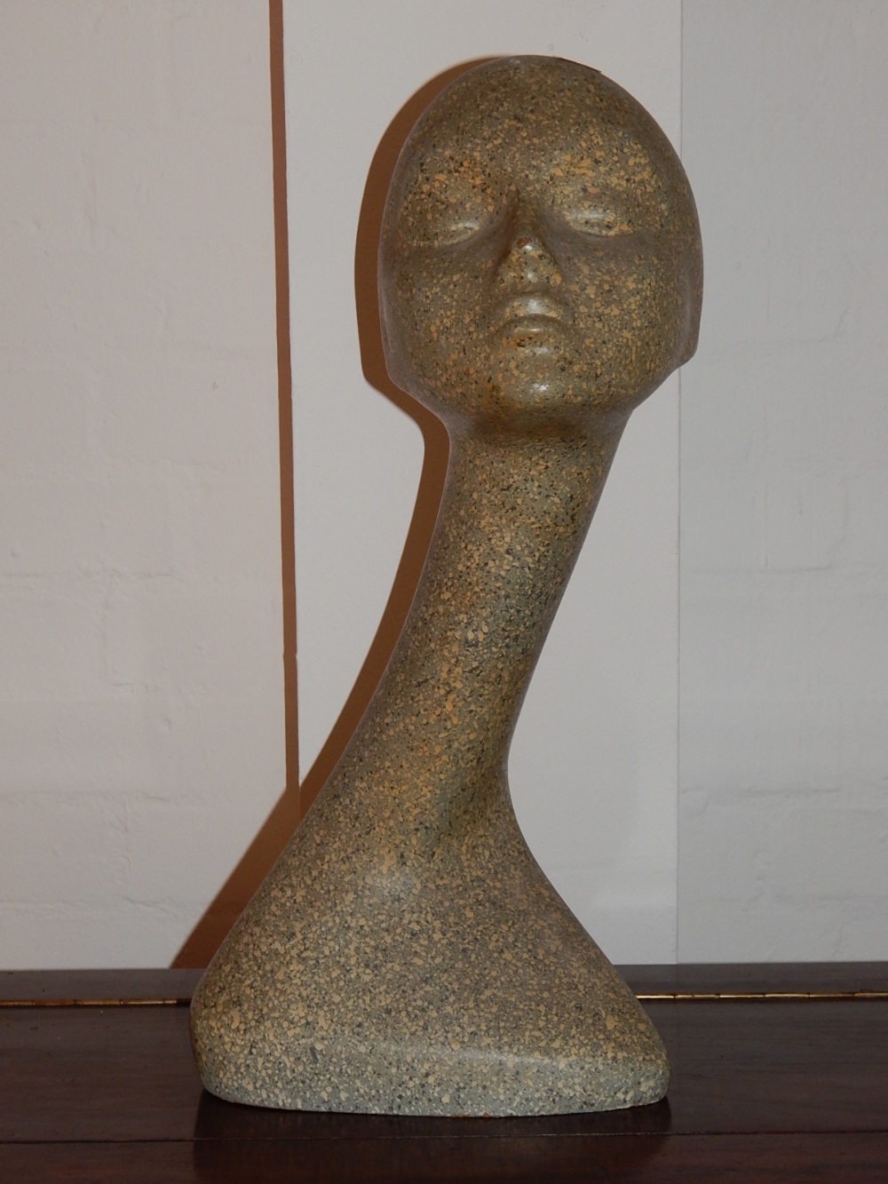 A 1960's stylised swan neck shop window mannequin head, in a marbled finish, signed and dated in