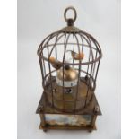 An automaton time-piece, in the form of two caged birds. H. 19cm
