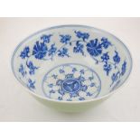 A Chinese celadon glazed porcelain bowl, the interior decorated in blue with scrolling foliage on