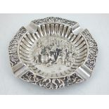 A Dutch white metal ashtray, with pierced border and embossed decoration to centre, stamped 900.