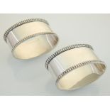 A pair of silver napkin rings, Birmingham 1975, of oval form, 64g. (2).