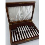 A Mappin & Webb mother of pearl handled dessert knife and fork set, boxed.