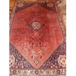 A red ground Qashqai carpet, central octagonal medallion on a geometric ground, fringed 240x158