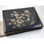 An early 20th century Shibayama type photograph album, the cover decorated with birds amongst