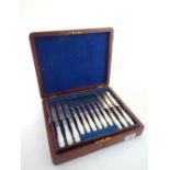 A silver plate and mother of pearl handled cutlery set, boxed, together with one other cutlery set