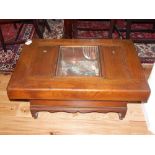 A 20th century Korean hardwood low table, with a central glazed recess flanked by further lidded