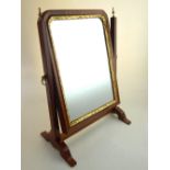 A George II design walnut toilet mirror with gilt slip.