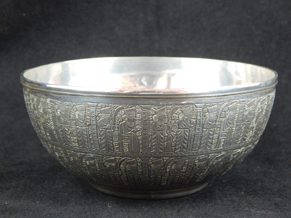 An early 20th century coin dish, engraved with a continuous design of figures, purity marks to base.