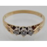 A 9ct yellow gold and three stone diamond ring, stamped 375 to shank.