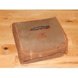 An early 20th century black stained crocodile skin travelling toilet case with canvas outer cover