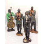 Four plaster cast and polychrome painted figures of jazz musicians, H. 54cm