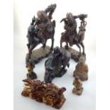 Two Chinese rootwood carvings of men on horseback together with a similar smaller carving a Malay