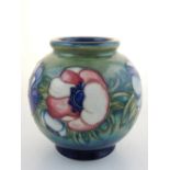 A Moorcroft globe shaped vase, anemone pattern with stamp and signature to base, H. 15cm.