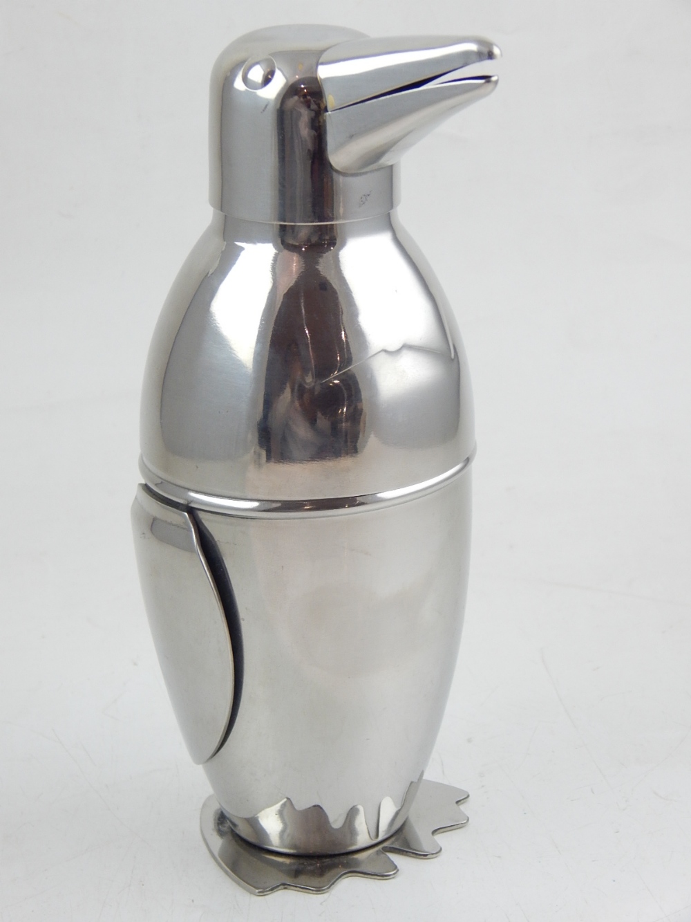 A plated novelty penguin cocktail shaker.