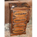 An oriental hardwood chest of drawers, with cut steel mounts and an arrangement of four drawers,