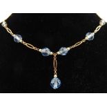 A 9ct yellow gold and pearl and blue topaz beaded necklace.