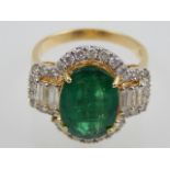 An 18ct yellow gold, emerald and diamond dress ring, the oval cut emerald of approx.4.18ct, diamonds