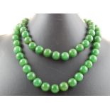 A green hardstone necklace, of uniform beads,