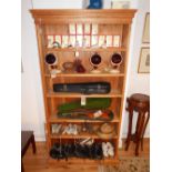 A pine open bookcase, with a moulded dentil cornice above adjustable shelves, W. 107cm.