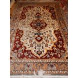 A Chinese silk carpet, stepped floral medallion to centre, foliate cream ground and grey borders,