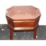 A George III style mahogany cellerette, rectangular with canted corners, a brass band and drop