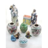 A collection of Chinese ceramics comprising four glazed earthenware figures, a green glazed vase and