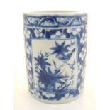 A 19th century Chinese blue and white brush pot, decorated with two square panels of wildlife,
