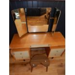 A G-plan oak mirrored back dressing table, the triple plate mirror above an arrangement of five