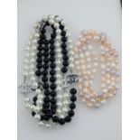 A Chanel style pearl necklace, together with another pearl necklace.